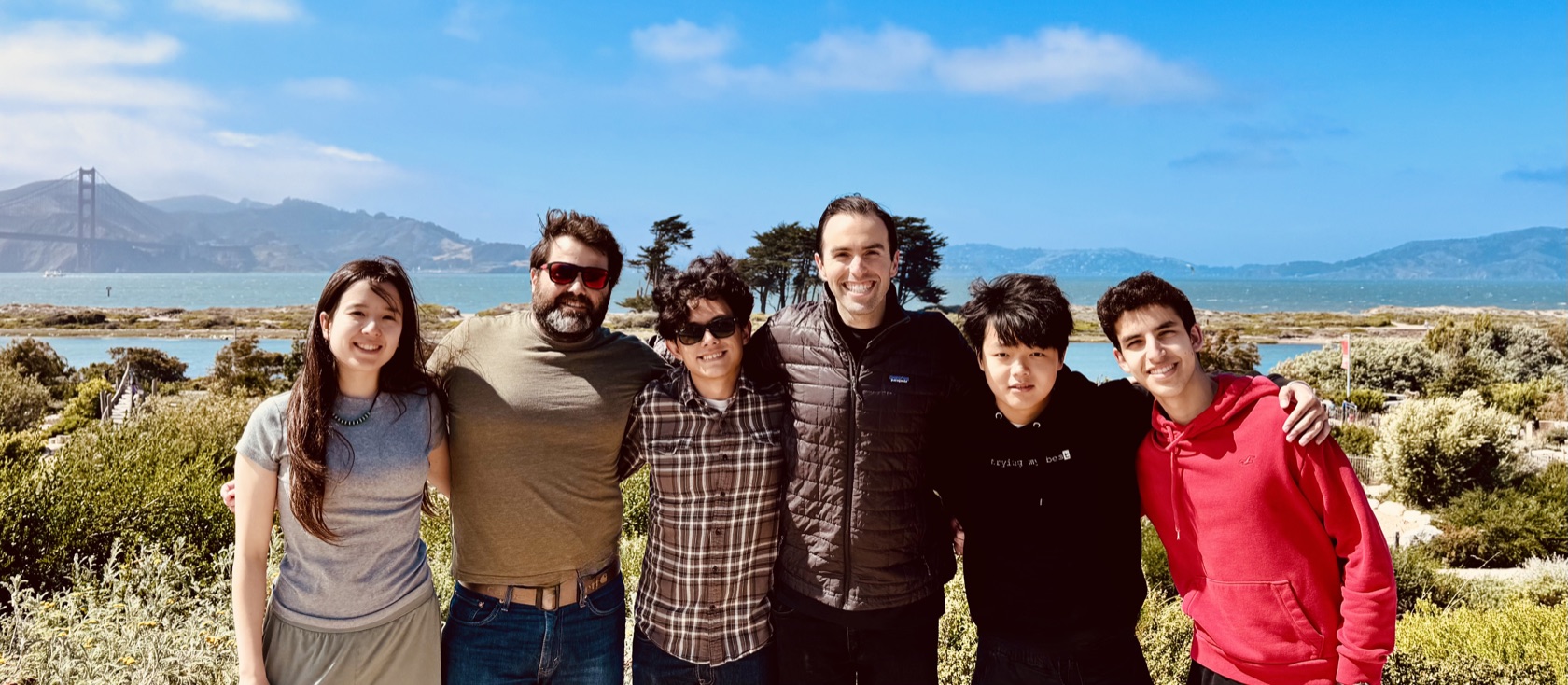 The Orca Aerospace team standing together outdoors, with San Francisco Bay and the Golden Gate Bridge behind them